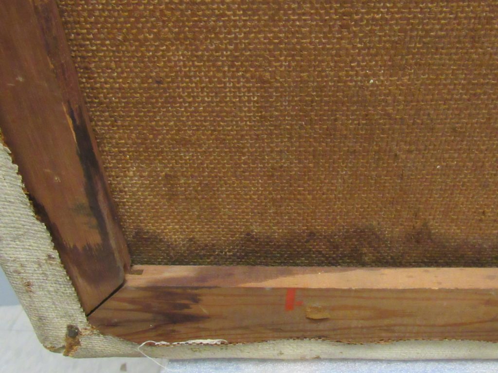 Detail of back of painting with tidelines from water damage.